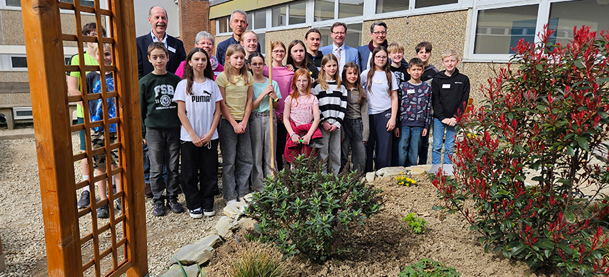 Michael Hauer mit Verantwortlichen und Schülerinnen und Schülern auf dem umgestalteten Schulhof der Friedrich-Spee-Realschule plus in Neumagen-Dhron, Foto MKUEM